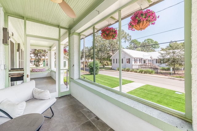 sunroom / solarium featuring ceiling fan and a wealth of natural light