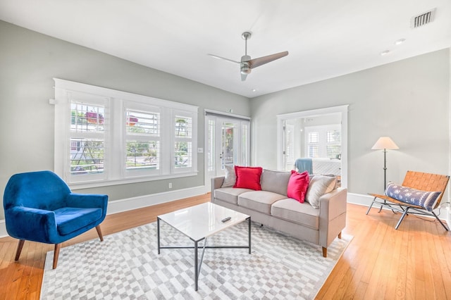 living room featuring ceiling fan and light hardwood / wood-style flooring