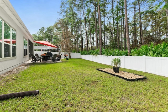 view of yard featuring a patio area and a fenced backyard