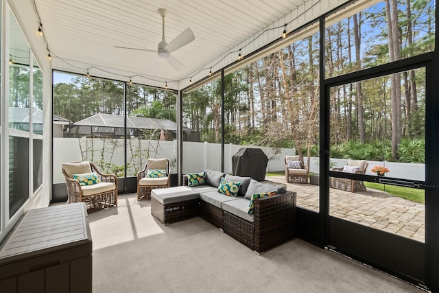 sunroom featuring a ceiling fan