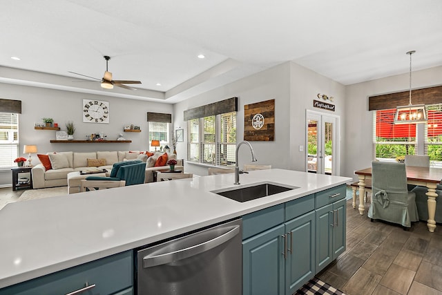 kitchen featuring stainless steel dishwasher, light countertops, french doors, and a sink