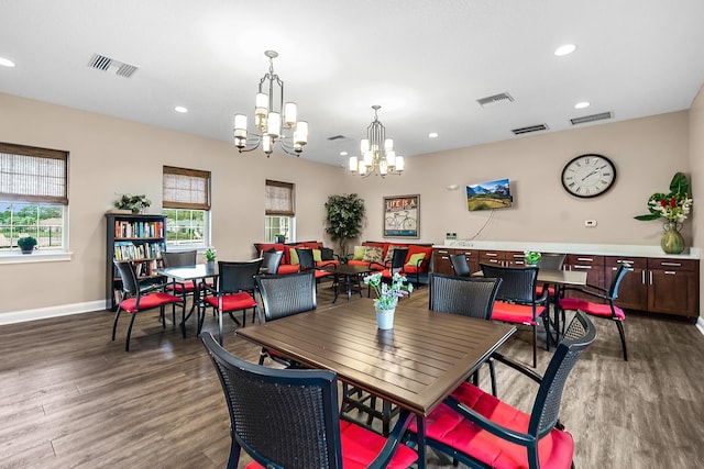 dining space featuring dark hardwood / wood-style floors and a chandelier