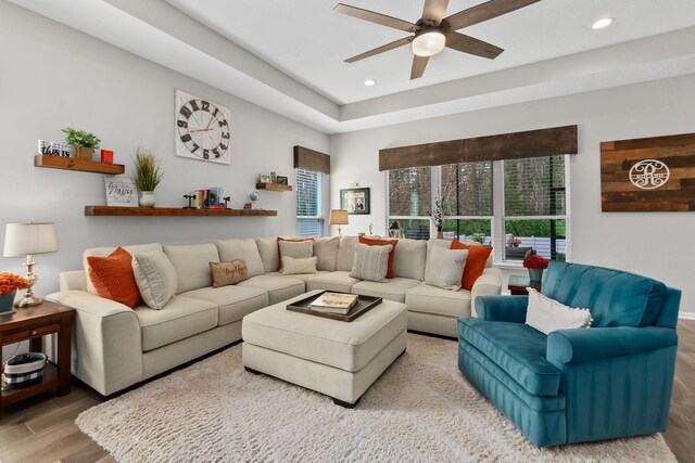 living room with hardwood / wood-style flooring and ceiling fan