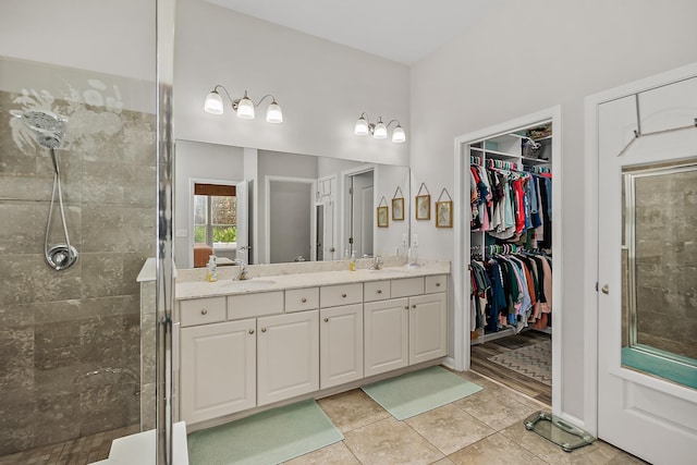 bathroom with vanity, an enclosed shower, and tile patterned flooring