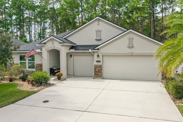 view of front of home featuring stucco siding, stone siding, roof with shingles, concrete driveway, and a garage