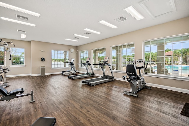 gym with dark hardwood / wood-style floors