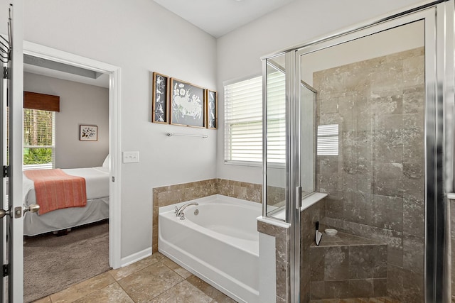 bathroom with tile patterned flooring, a shower stall, baseboards, a garden tub, and ensuite bathroom