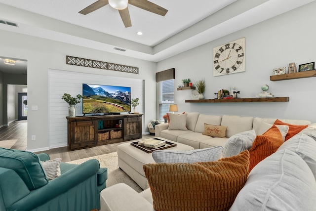 living room with light hardwood / wood-style flooring and ceiling fan