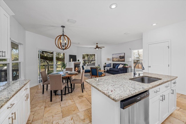 kitchen with sink, an island with sink, white cabinets, and dishwasher