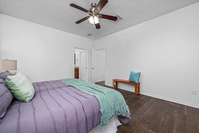 bedroom with ceiling fan, dark hardwood / wood-style floors, and a textured ceiling