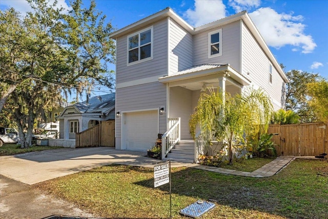 view of front of property with a garage and a front yard