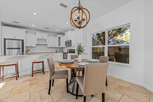 dining space featuring a notable chandelier