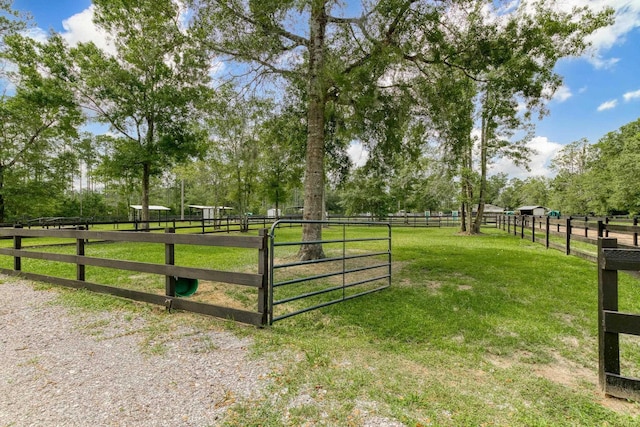 view of gate with a rural view