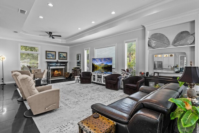 bar with ceiling fan and dark stone countertops