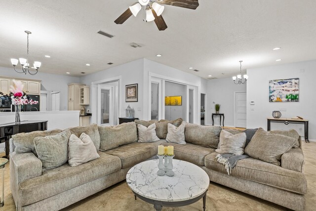 dining space with french doors, a textured ceiling, and an inviting chandelier