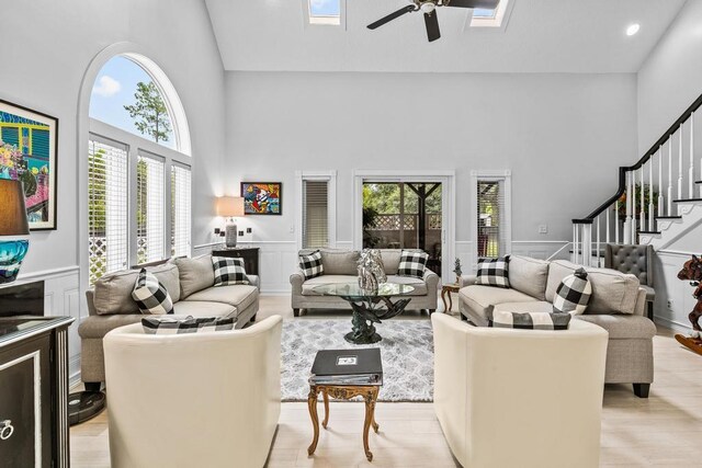 interior space with a stone fireplace, light hardwood / wood-style floors, a textured ceiling, and ornamental molding