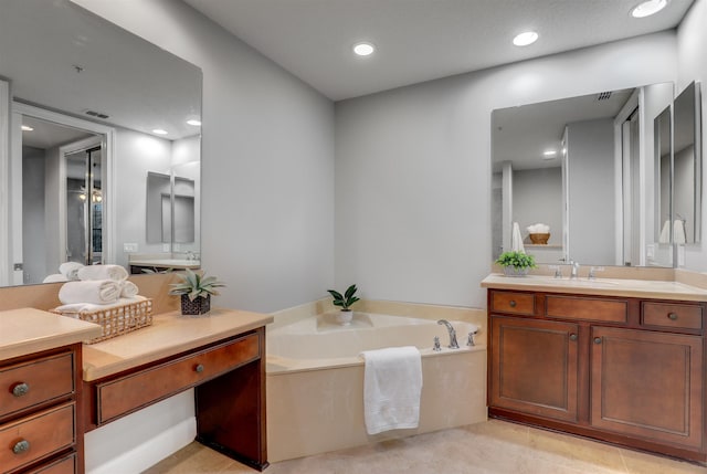 bathroom featuring a tub to relax in, tile patterned flooring, and vanity