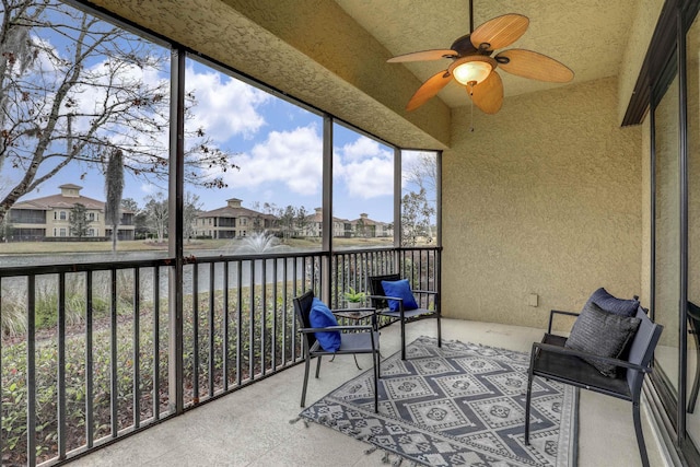 sunroom / solarium featuring ceiling fan