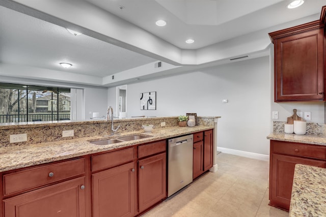 kitchen featuring light stone counters, stainless steel dishwasher, and sink