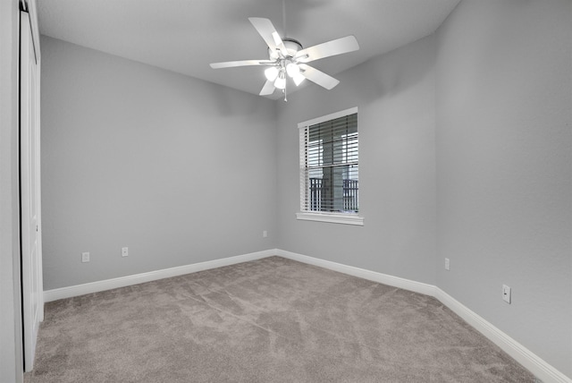 unfurnished room featuring ceiling fan and light colored carpet