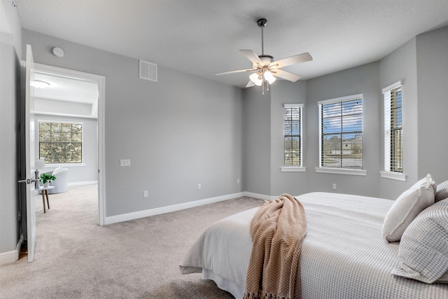 bedroom featuring ceiling fan and light colored carpet