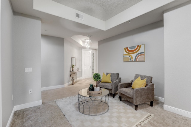 carpeted living room with a textured ceiling