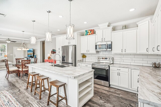 4954 A1A, Saint Augustine, FL 32080 - kitchen featuring appliances with stainless steel finishes, tasteful backsplash, recessed lighting, dark wood-type flooring, and white cabinets