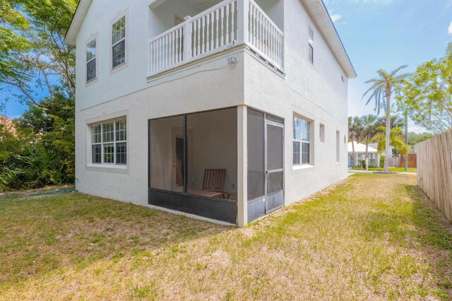 2 Lisbon St, Saint Augustine, FL 32080 - back of property featuring a balcony, stucco siding, and a sunroom