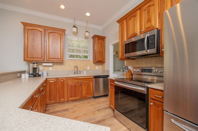 2 Lisbon St, Saint Augustine, FL 32080 - kitchen featuring stainless steel appliances, a sink, light countertops, decorative backsplash, and ornamental molding