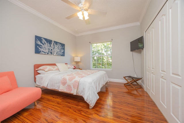 2 Lisbon St, Saint Augustine, FL 32080 - bedroom featuring wood finished floors, ornamental molding, a closet, baseboards, and ceiling fan