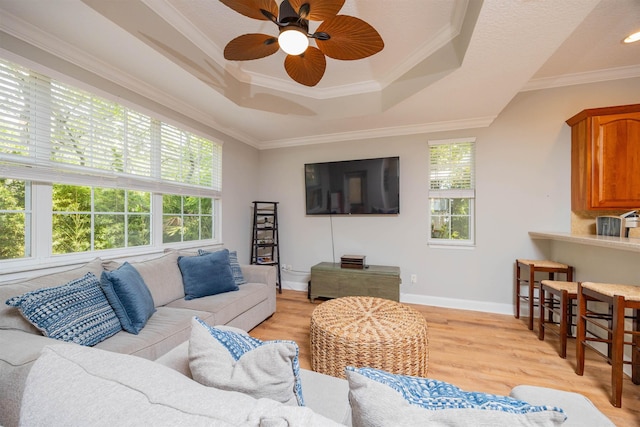2 Lisbon St, Saint Augustine, FL 32080 - living room featuring ceiling fan, light wood-style floors, a tray ceiling, baseboards, and crown molding