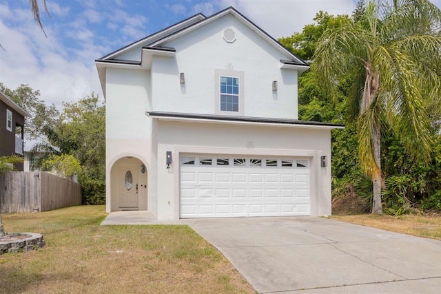 2 Lisbon St, Saint Augustine, FL 32080 - view of front of house with an attached garage, driveway, and stucco siding