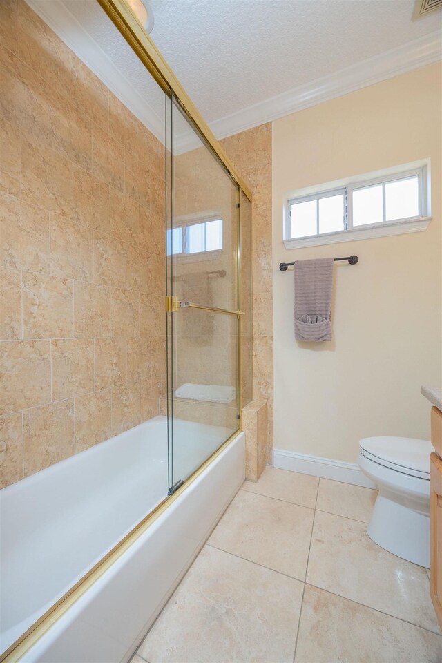 2 Lisbon St, Saint Augustine, FL 32080 - bathroom featuring crown molding, toilet, combined bath / shower with glass door, tile patterned flooring, and baseboards