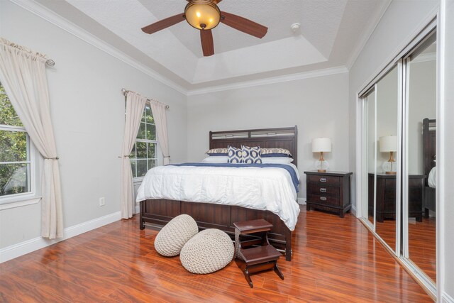 2 Lisbon St, Saint Augustine, FL 32080 - bedroom with access to outside, wood finished floors, multiple windows, ornamental molding, and a tray ceiling