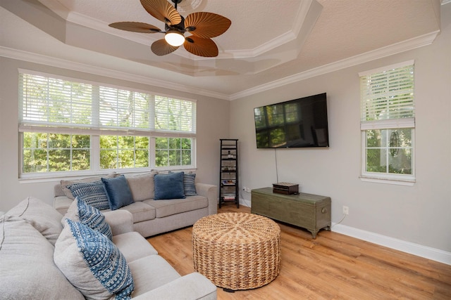 2 Lisbon St, Saint Augustine, FL 32080 - living area featuring a raised ceiling, light wood finished floors, ornamental molding, a ceiling fan, and baseboards