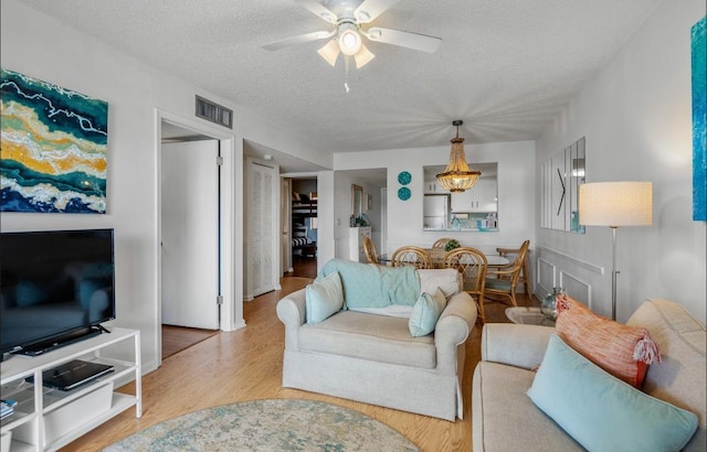 880 A1A Beach Blvd, Saint Augustine Beach, FL 32080 - living room with a textured ceiling, visible vents, a ceiling fan, and wood finished floors