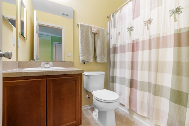 full bathroom featuring tile patterned flooring, shower / bath combination with curtain, vanity, and toilet