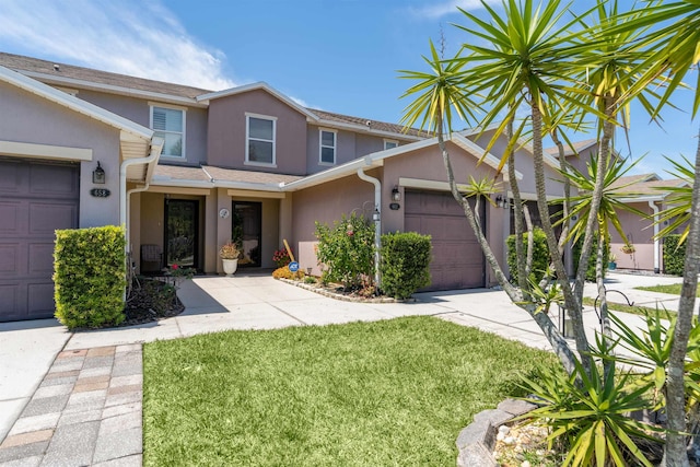 view of front of house featuring a front lawn and a garage