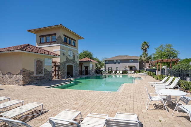 view of swimming pool featuring a pergola, a patio, and an outdoor fireplace