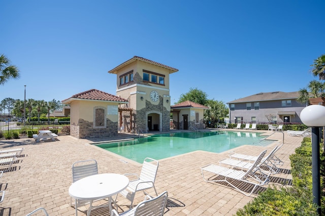 view of pool featuring a patio area and exterior fireplace