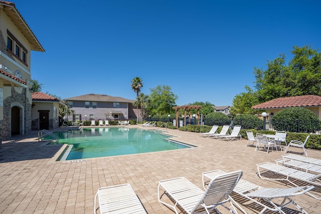 view of pool featuring a patio area and an outdoor fireplace