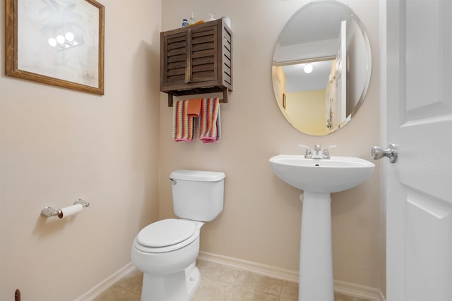 bathroom featuring tile patterned flooring, toilet, and sink