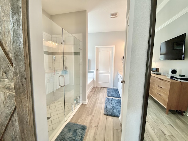 118 Sierras Loop, Saint Augustine, FL 32086 - full bath with a stall shower, vanity, a garden tub, wood finished floors, and ornamental molding