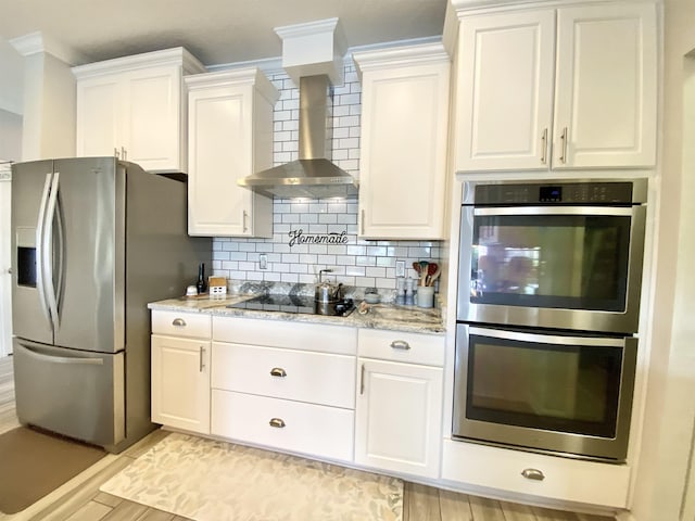 118 Sierras Loop, Saint Augustine, FL 32086 - kitchen with appliances with stainless steel finishes, wall chimney range hood, white cabinetry, decorative backsplash, and crown molding