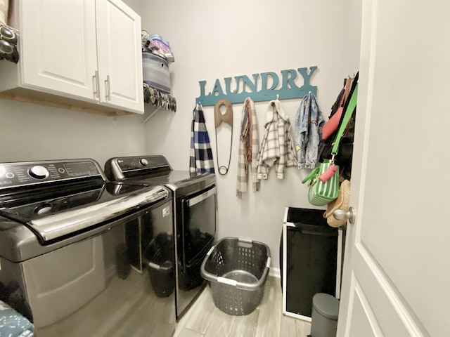 118 Sierras Loop, Saint Augustine, FL 32086 - laundry area featuring independent washer and dryer, cabinet space, and wood finished floors
