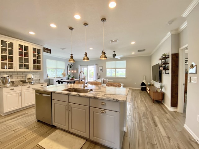 118 Sierras Loop, Saint Augustine, FL 32086 - kitchen featuring stainless steel dishwasher, light wood finished floors, crown molding, a kitchen island with sink, and recessed lighting