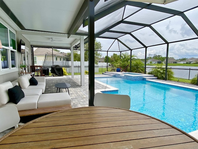118 Sierras Loop, Saint Augustine, FL 32086 - view of swimming pool featuring a patio, a ceiling fan, a pool with connected hot tub, a lanai, and a water view