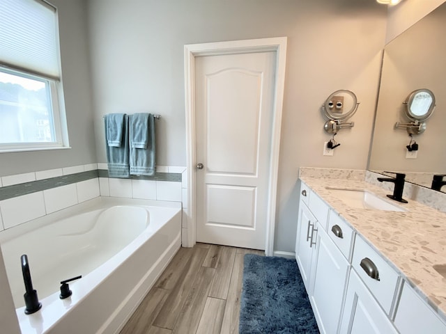 118 Sierras Loop, Saint Augustine, FL 32086 - bathroom featuring vanity, a bath, and wood finished floors