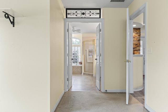 4 Eastgate Ln, Palm Coast, FL 32164 - hall with light colored carpet, baseboards, and light tile patterned floors