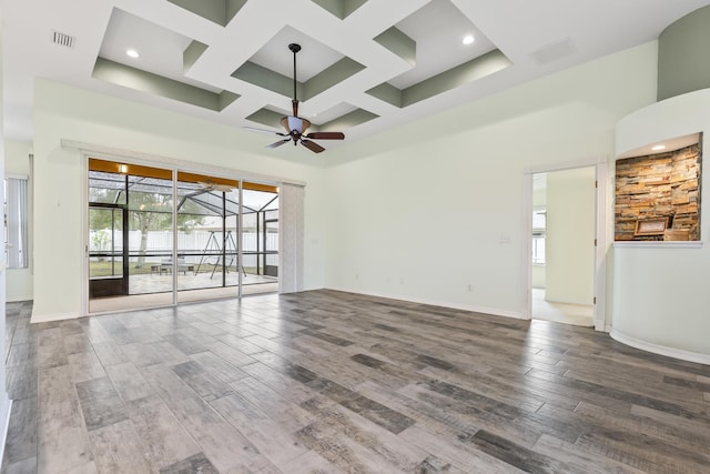 4 Eastgate Ln, Palm Coast, FL 32164 - spare room with a ceiling fan, a high ceiling, coffered ceiling, healthy amount of natural light, and wood finished floors